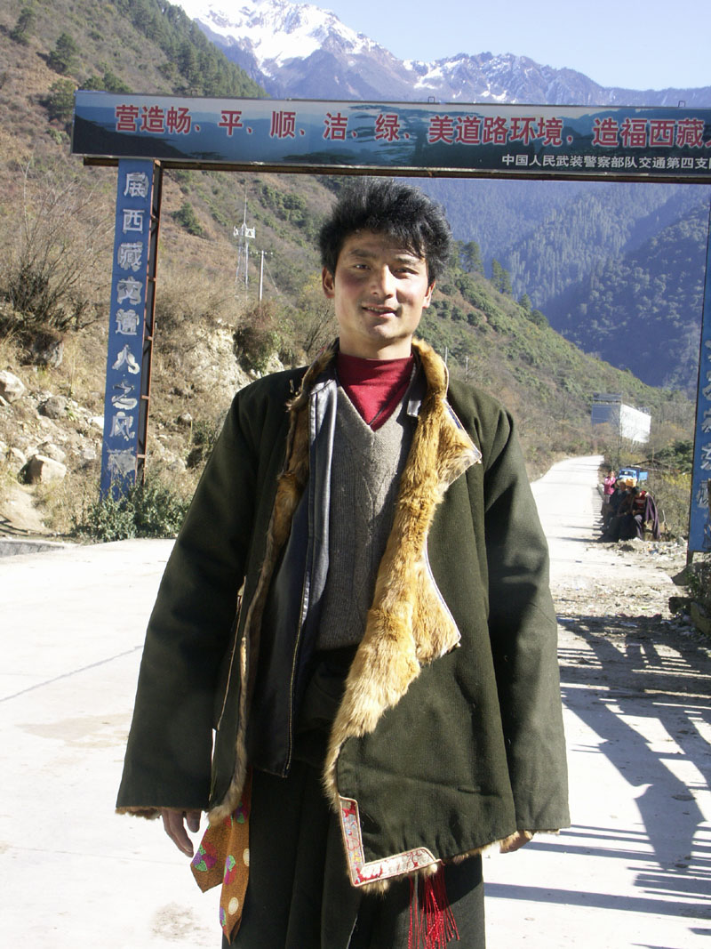 腰間佩藏刀，熱情的康巴年輕小伙子，一路唱歌給全車乘客聽