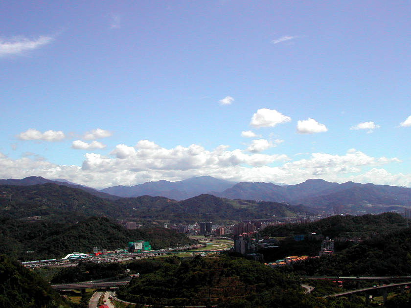 富德公墓 (萬芳交流道上方一帶) 往南看，正中線由近而遠大致是灰窯坑山、景美溪上的捷運橋與萬壽橋、高麗坑山、北插天山。