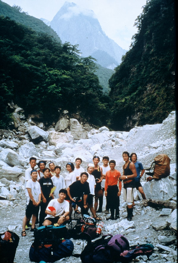 攀登隊與運補隊於二子溫泉旁合照, 背景是針山.